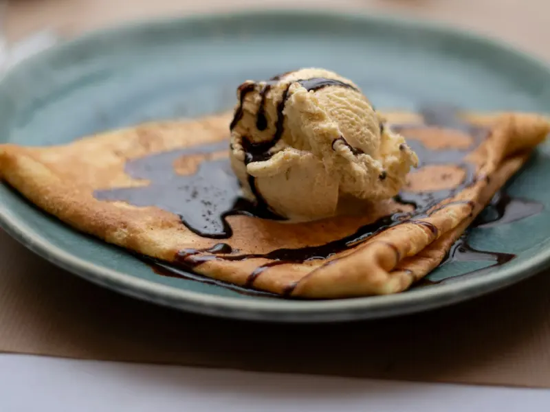 Crêpe avec une boule de glace vanille et un filet de chocolat